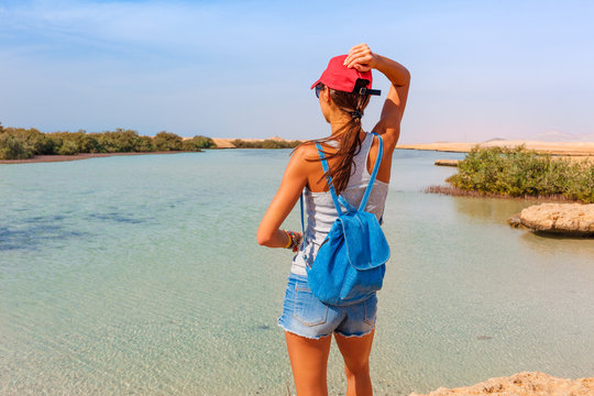 Tourist woman at the Red Sea coast and mangroves in the Ras Mohammed National Park. Famous travel destionation in desert. Sharm el Sheikh, Sinai Peninsula, Egypt.