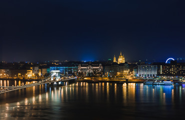 Fototapeta na wymiar Night view of Budapest. Panorama cityscape of famous tourist destination with Danube, parliament and bridges. Travel illuminated landscape in Hungary, Europe.