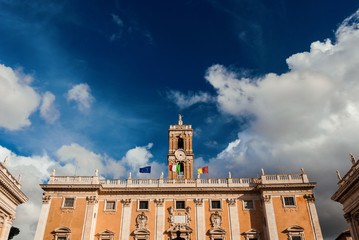 Rome City Hall with old clock tower among clouds at the top of Capitoline Hill in the center of...