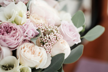 Wedding bouquet of roses and peonies. Bridal bouquet on wedding day. Different flowers of pink, violet and white blossoms