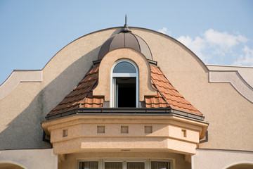 Vintage dormer and window on roof at house. Retro style toned facade and architecture concept. Close up
