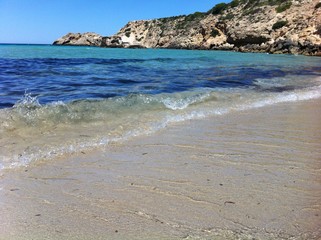 Cala Tarida in Ibiza beach. azure blue sea water with transparent wave