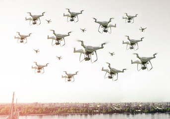 Swarm of drones flying over the city  - obrazy, fototapety, plakaty