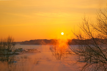 Fototapeta na wymiar Coast and the river Kostroma, Russia, on a clear frosty winter day at sunset.