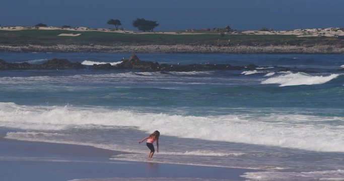 Girl Playing in Ocean Waves