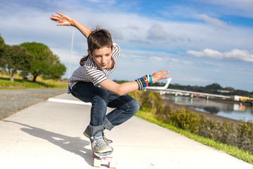 outdoor portrait of young preteen boy skating on urban background