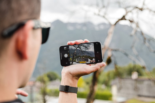 Man making photo of nature landscape on smartphone