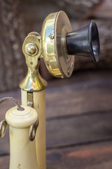 Antique 1913 candlestick telephone, in rare white aged colour, vintage concept.