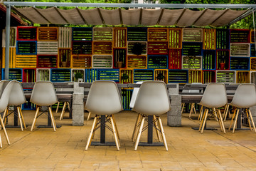 small and cheap outdoor street patio cafe with cute plastic furniture table and shairs