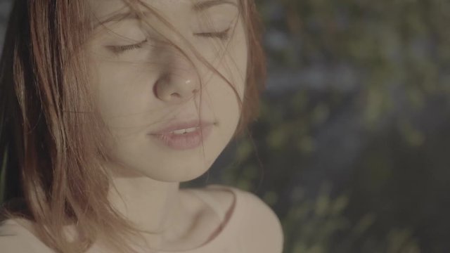 Portrait of a beautiful red-haired positive girl in a park, color profile Slog3