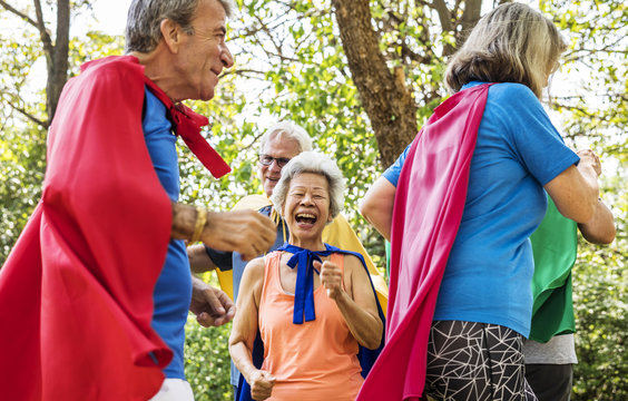 Childlike seniors wearing superhero costumes