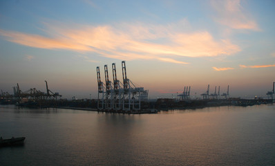 Obraz premium Dawn over a working cargo port.