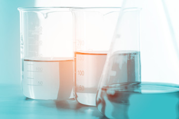 A pipette dropping sample into a test tube,abstract science background