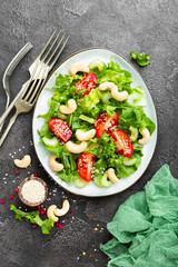 Salad with fresh vegetables and nuts. Vegetable salad with fresh vegetables and cashew. Vegetable salad on plate. Healthy vegetarian food