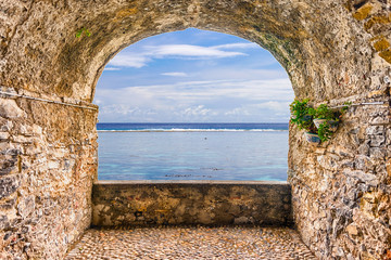 Rock balcony overlooking a tropical beach, French Polynesia