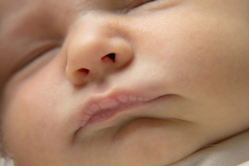 portrait of newborn baby. nose and lips close up. Concept of healthcare: diseases of the ENT, lips, mouth