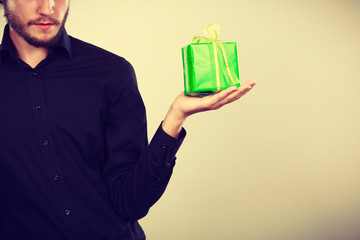 man holding present green gift box in hand