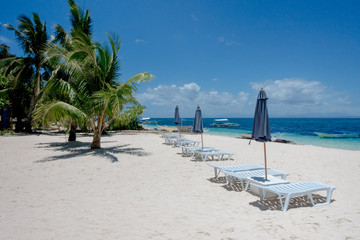 Sunbeds and beach umbrellas in a vacation paradise - Bohol, Philippines