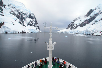 Cruise expedition ship in a narrow channel on the Antarctic Peninsula © Chris
