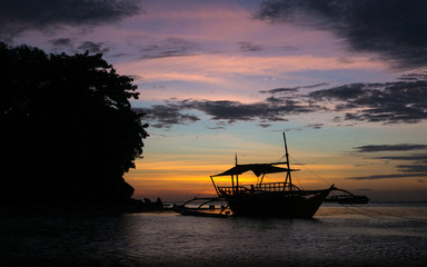 Fototapeta premium Large boat silhouette against incredible tropical sunrise - Cebu, Philippines