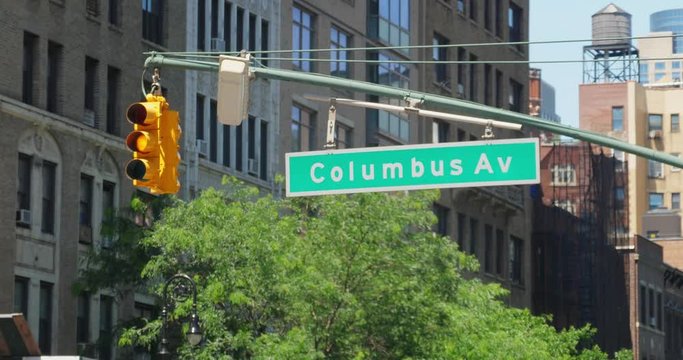 A daytime establishing shot of a Columbus Avenue street sign.  	