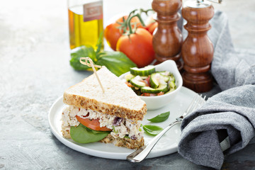 Chicken salad sandwich with spinach and tomato