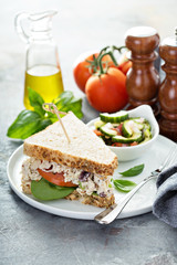 Chicken salad sandwich with spinach and tomato