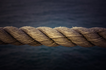 old marine rope on the pebble beach