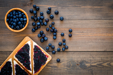 Sandwiches with blueberry jam for breakfast on dark wooden background top view copy space