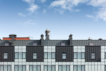 roof of a modern office building with various pipes for ventilation and conditioning