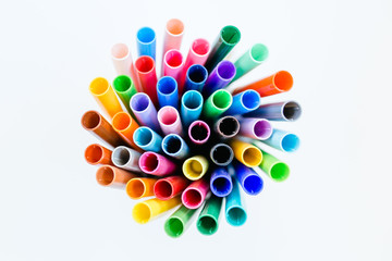 Rainbow burst of markers in a circular pattern on a white isolated background 