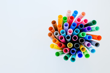 Group of colorful markers in a radial pattern on a white isolated background 