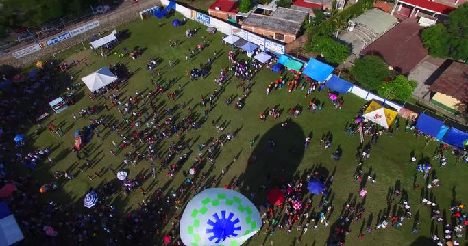 Crowd launching small air balloons.