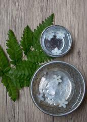 Water in silver bowl with white flower. Thailand Songkran festival decoration concept.