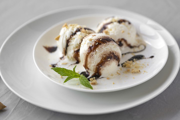 Vanilla Ice Cream with Mint in bowl and chocolate sauce