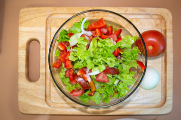 Salad from greens, tomatoes, peppers and onions