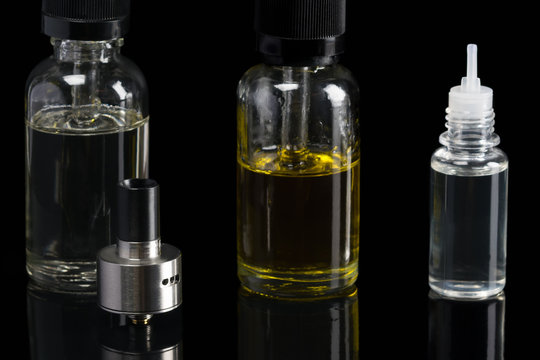 set of liquids of different flavors for an electronic cigarette on a black background
