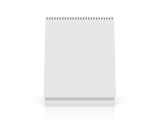 A paper white calendar stands on the table