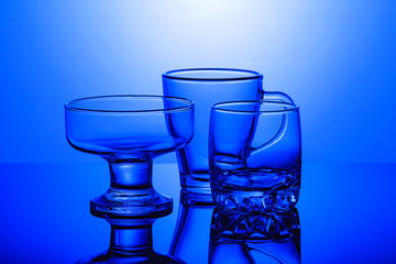 Transparent glasses on a blue background