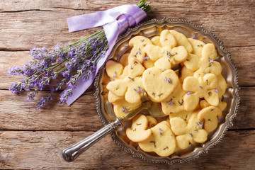 Delicious dessert food: lavender shortbread cookies close-up on a plate. Horizontal top view from...