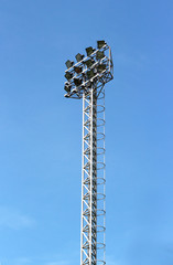 Spotlight Standing Tall on Blue Sky Background.