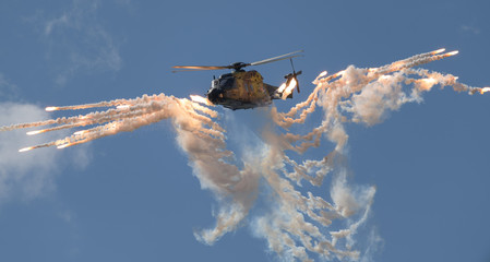 Military helicopter shooting flares