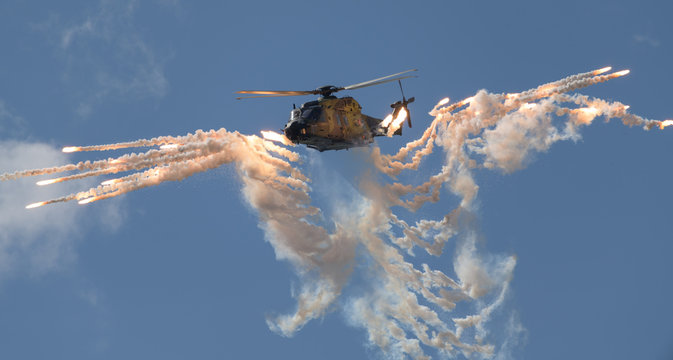 Military helicopter shooting flares
