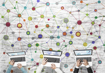 Top view of businesspeople sitting at table and using gadgets