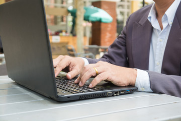 Hand of Businessman typing on Notebook or Laptop Computer