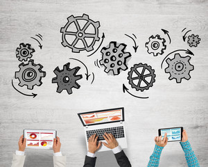 Top view of businesspeople sitting at table and using gadgets