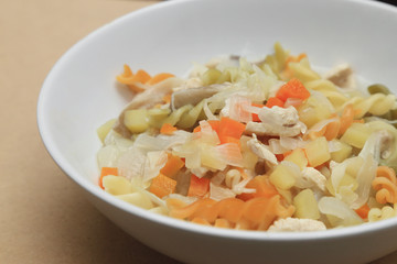 Macaroni soup with chicken, potato, carrot and onion.