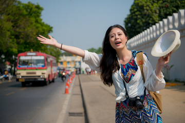 woman waving her hands to get on the tuk-tuk