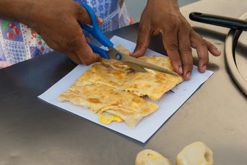 Chef making roti and egg.
