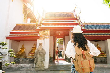 Asian woman standing in front the gate